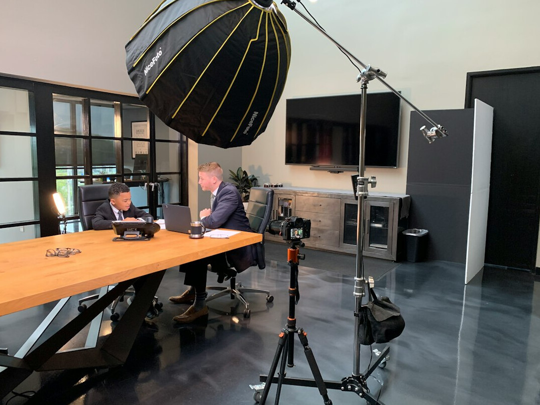 Television news studio set with desk and screens
